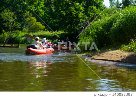 Rafting group paddling bright inflatable kayaks along river bank, outdoor water adventure, summer sport tourism, teamwork recreation. Rafting group paddling bright inflatable kayaks along river bank, outdoor water adventure, summer sport tourism, teamwork recreation. 140085398