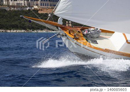 Close up on the bow of a sailboat breaking through a wave Close up on the bow of a sailboat breaking through a wave 140085603