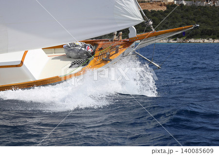 Close up on the bow of a sailboat breaking through a wave Close up on the bow of a sailboat breaking through a wave 140085609