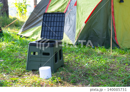 Camping tent with portable toilet on green grass, nature tourism area, outdoor hygiene solution for convenience and sanitary travel application. Camping tent with portable toilet on green grass, nature tourism area, outdoor hygiene solution for convenience and sanitary travel application. 140085731