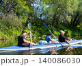 Family paddling the Varzuga kayak on the river, energetic teamwork and active summer adventure, nature recreation for parents and child. 140086030
