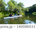 Family in the Vuoksa kayak enjoying a peaceful river paddle, harmony, tradition, and healthy active lifestyle for everyone. 140086033