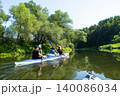 Family paddling a Vuoksa kayak on the river, family water trip, shared outdoor adventure. 140086034