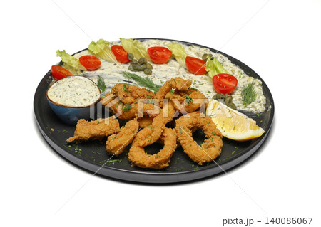 plate of squid on isolated white background. With sauces. plate of squid on isolated white background. With sauces. 140086067