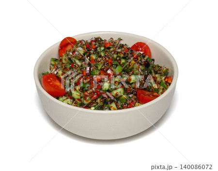 Healthy mixed salad in white bowl on wooden table. Mediterranean salad Healthy mixed salad in white bowl on wooden table. Mediterranean salad 140086072