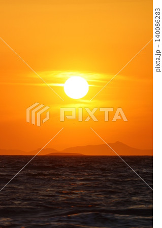 Close-up of empty sky and sun for copy space. The spectacular view of the sunset was breathtaking, with the sun sinking behind the clouds on the horizon. 140086283