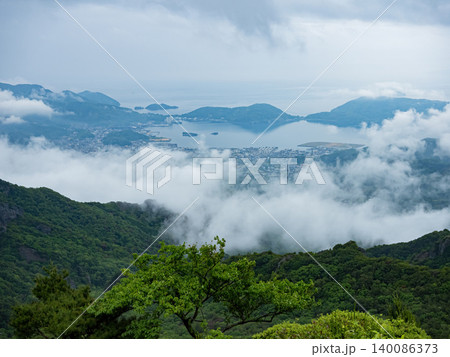 Misty panoramic landscape of Shodoshima Island with Seto Inland Sea, mountain ridges and drifting clouds. 140086373