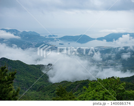 Misty panoramic landscape of Shodoshima Island with Seto Inland Sea, mountain ridges and drifting clouds. 140086374