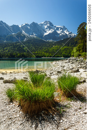 Travel landscape of Eibsee lake and Zugspitze mountains peak Alps in Bavaria, Germany, scenic summer nature panorama with forest and beach Travel landscape of Eibsee lake and Zugspitze mountains peak Alps in Bavaria, Germany, scenic summer nature panorama with forest and beach 140086608