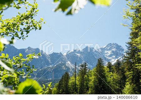 Travel landscape of Zugspitze mountain in Alps in Bavaria, Germany, scenic summer nature panorama with forest, snow mountains peak 140086610