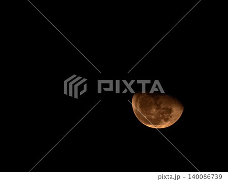 Dramatic Blood Moon Half Phase in Dark Night Sky 140086739