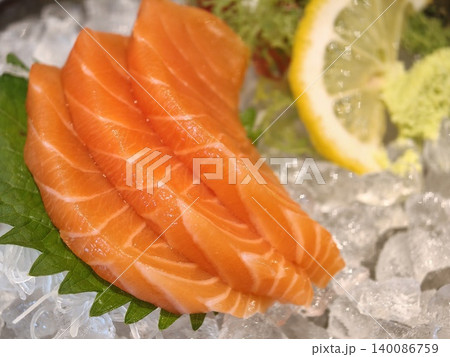 Fresh Salmon Sashimi Slices on Ice with Lemon Fresh Salmon Sashimi Slices on Ice with Lemon 140086759