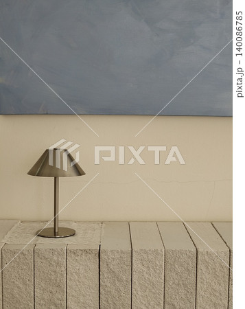 Minimalist Metal Table Lamp on Concrete Ledge Grey Wall Minimalist Metal Table Lamp on Concrete Ledge Grey Wall 140086785