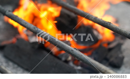 Fiery Charcoal Grill Blazing Hot Coals Under Metal Rods Fiery Charcoal Grill Blazing Hot Coals Under Metal Rods 140086883