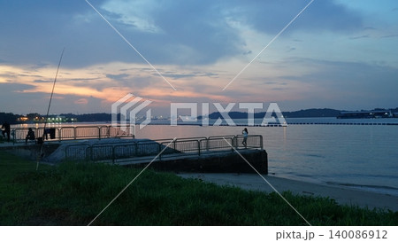 Beautiful Sunset Over Tranquil Coastal Fishing Spot Beautiful Sunset Over Tranquil Coastal Fishing Spot 140086912