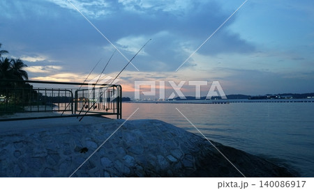Serene Evening Fishing Scene by the Tropical Coast Serene Evening Fishing Scene by the Tropical Coast 140086917