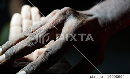 Deeply Textured Hands Bathed in Light and Shadow Deeply Textured Hands Bathed in Light and Shadow 140086944