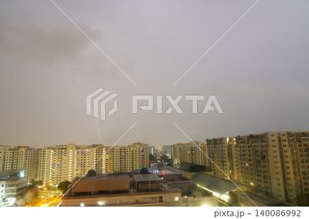 Lightning Strike Over City Buildings on a Cloudy Day 140086992