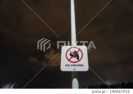 No Fishing Sign At Night By Water 140087058