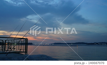 Serene Twilight Fishing Scene with Colorful Horizon Serene Twilight Fishing Scene with Colorful Horizon 140087070