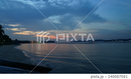 Peaceful Dusk Seascape with Reflective Ocean and Colorful Sky Peaceful Dusk Seascape with Reflective Ocean and Colorful Sky 140087081