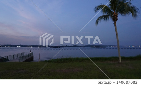 Peaceful Tropical Dusk Fishing by the Serene Waterfront Peaceful Tropical Dusk Fishing by the Serene Waterfront 140087082