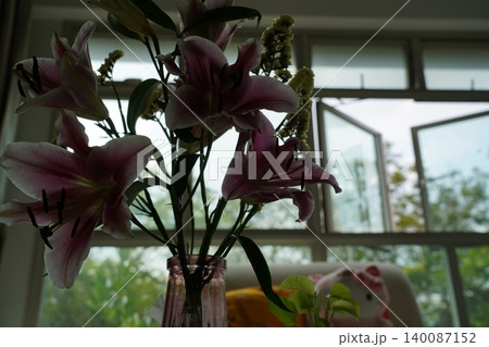 Pink Lilies in a Vase near an Open Window Pink Lilies in a Vase near an Open Window 140087152