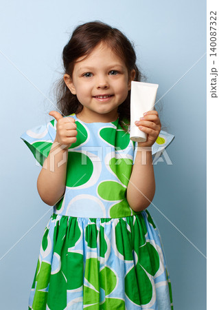 Happy little girl endorsing a product with a cheerful expression and showing thumbs up Happy little girl endorsing a product with a cheerful expression and showing thumbs up 140087322