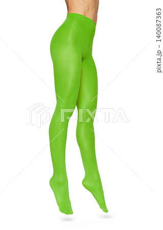 Woman wearing neon green tights on white background 140087363