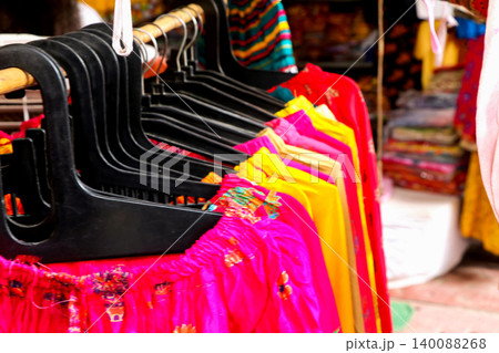 Colorful Women Clothes Hanging on Rack in Boutique Store Colorful Women Clothes Hanging on Rack in Boutique Store 140088268