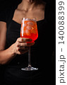 alcoholic red cocktail in hands 140088399