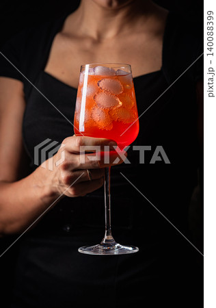 alcoholic red cocktail in hands 140088399