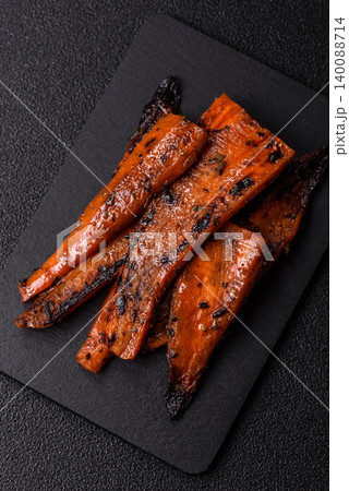 Grilled or barbecued carrot slices with salt and spices. Grilled carrots Grilled or barbecued carrot slices with salt and spices. Grilled carrots 140088714