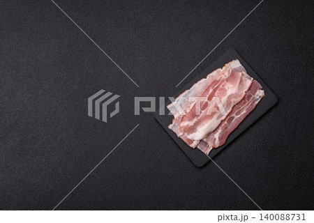 Raw fresh bacon slices with layers of meat or prosciutto with salt and spices. Raw bacon 140088731