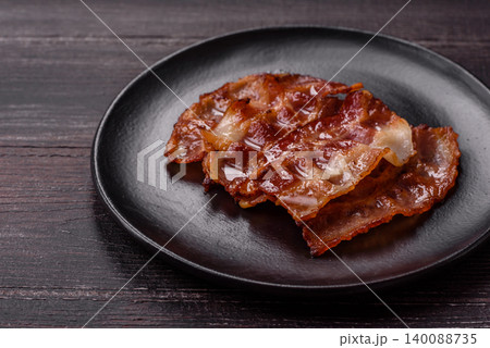 Fried fresh bacon slices with layers of meat or prosciutto with salt and spices. Fried bacon Fried fresh bacon slices with layers of meat or prosciutto with salt and spices. Fried bacon 140088735