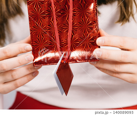 woman holds red gift bag in hands woman holds red gift bag in hands 140089093
