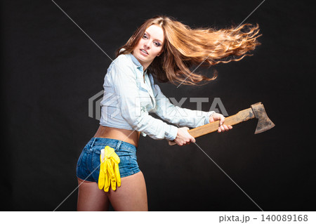 Sexy strong woman feminist with axe working. Sexy strong woman feminist with axe working. 140089168