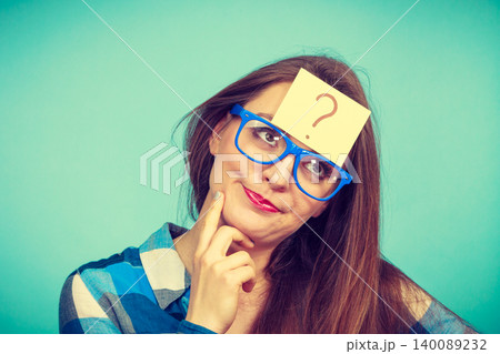 Thinking woman with big eyeglasses and light bulb Thinking woman with big eyeglasses and light bulb 140089232
