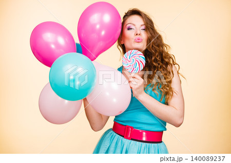 Woman with colorful balloons and lollipop Woman with colorful balloons and lollipop 140089237