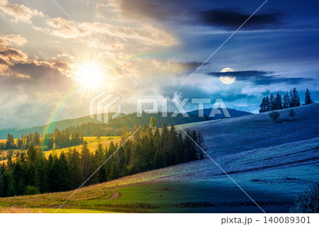 day meet night. mountain landscape on autumn equinox. sun and moon over green nature of carpathian mountains with fir forest. view of a scenery with rolling hills under epic sky. pasture near woods day meet night. mountain landscape on autumn equinox. sun and moon over green nature of carpathian mountains with fir forest. view of a scenery with rolling hills under epic sky. pasture near woods 140089301
