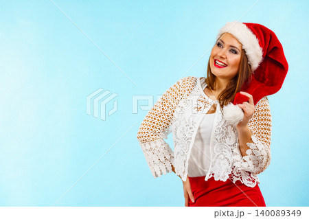 Smiling woman in christmas santa hat Smiling woman in christmas santa hat 140089349