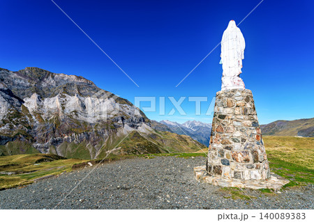 Blessed virgin Mary statue at Cirque de Troumouse, Heas in France. Meadows surrounded by dramatic mountain peaks Blessed virgin Mary statue at Cirque de Troumouse, Heas in France. Meadows surrounded by dramatic mountain peaks 140089383