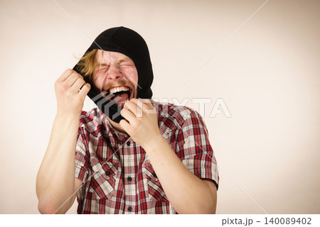 Sad man wearing balaclava 140089402