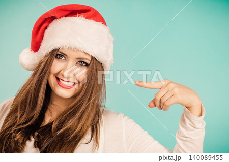 Woman in christmas santa hat on blue Woman in christmas santa hat on blue 140089455