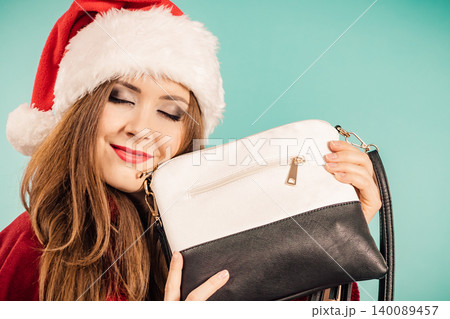 Christmas girl holding handbag present Christmas girl holding handbag present 140089457