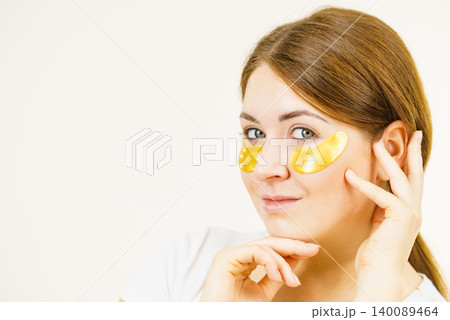 Woman with gold patches under eyes Woman with gold patches under eyes 140089464
