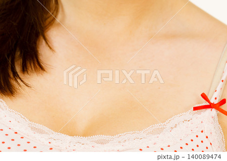 Woman in underwear shirt showing her neckline 140089474