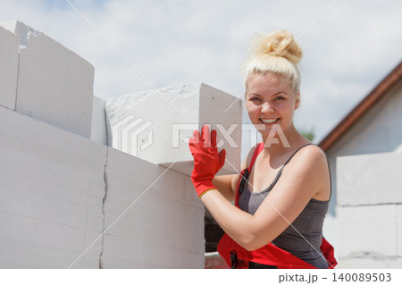 Woman working with airbricks Woman working with airbricks 140089503