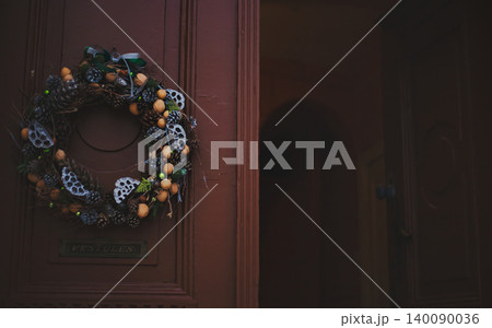 Festive winter wreath adorned with pine cones Festive winter wreath adorned with pine cones 140090036