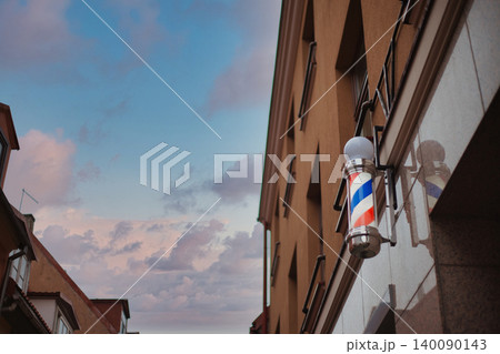 Classic Barber Pole Sign on a Modern Building Facade  140090143